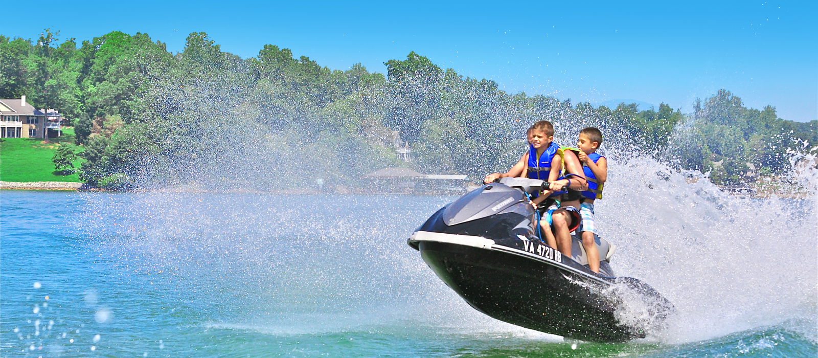 Father and son enjoying riding on jetski