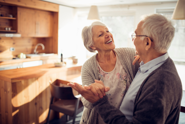 Senior couple dancing in kitchen