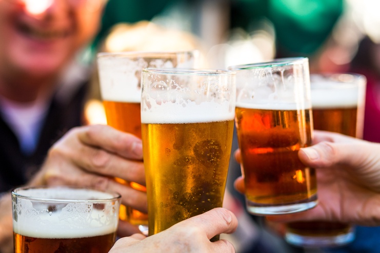 Group of friends toasting mug of beers in Smith Mountain Lake