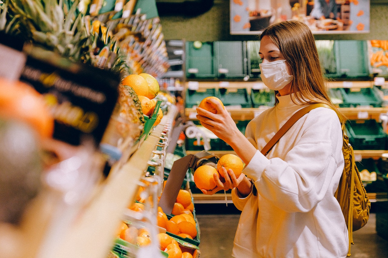 a woman shopping for some fruits