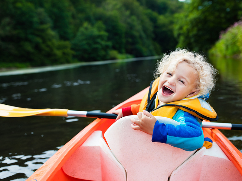 Smiling Kid riding boat