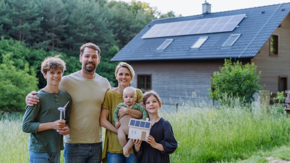Happy Family Holding Wind Turbine and Paper house